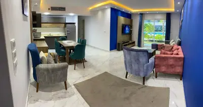 a living room with chairs and a dining room at Fanadir Chalet 3BR in Hurghada