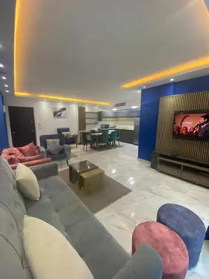 a living room with a couch and chairs and a tv at Fanadir Chalet 3BR in Hurghada