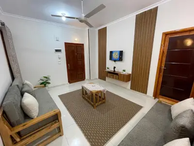a living room with a couch and a tv at Luxe Nest Luxor Serviced Apartments 201 in Luxor