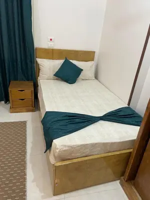 a bedroom with a bed with a blue blanket on it at Luxe Nest Luxor Serviced Apartments 201 in Luxor