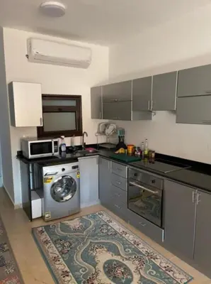 a kitchen with a washing machine and a microwave at Turtle beach resort in Hurghada