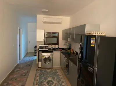 a kitchen with a refrigerator and a washing machine at Turtle beach resort in Hurghada