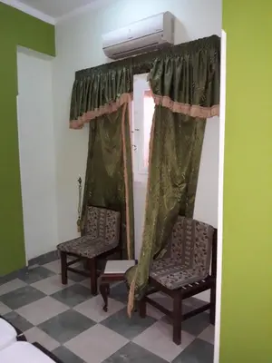 a room with two chairs and a window at Obelisk house in Luxor