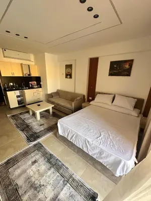 a bedroom with a large bed and a couch at Sahl Hasheesh in Hurghada