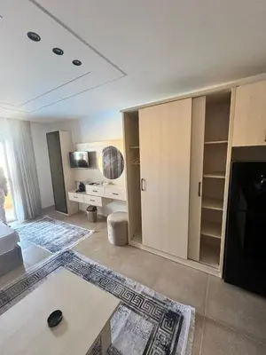 a living room with a bed and a desk at Sahl Hasheesh in Hurghada