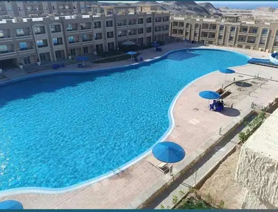 an overhead view of a large swimming pool with umbrellas at Sahl Hasheesh in Hurghada