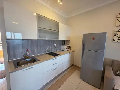 a kitchen with a stainless steel refrigerator and a sink at New studio in the view in Hurghada