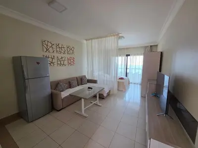 a living room with a couch and a tv in it at New studio in the view in Hurghada