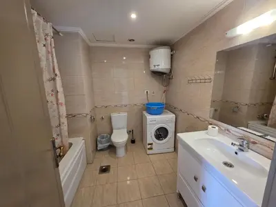 a bathroom with a sink and a washing machine at New studio in the view in Hurghada