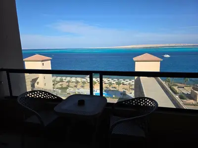 a balcony with chairs and a view of the ocean at New studio in the view in Hurghada