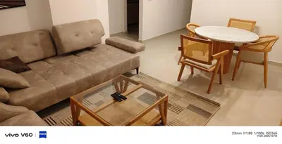 a living room with a couch and a table and chairs at Moon Hills Palace in Hurghada