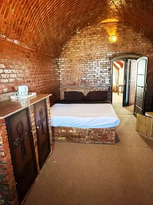 a bedroom with a bed in a brick wall at Villa Shanhouri Nile View in Luxor