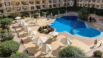an overhead view of a pool with umbrellas and chairs at Hurghada ,Mo&Kate Florenza Khamsin in Hurghada