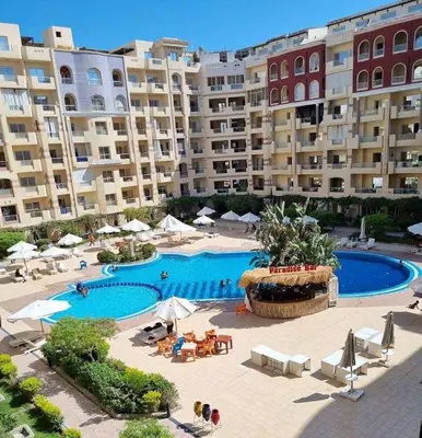 a large swimming pool in front of a large building at Hurghada ,Mo&Kate Florenza Khamsin in Hurghada