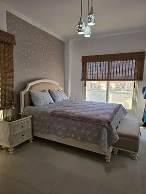 a bedroom with a large bed and a window at Hurghada ,Mo&Kate Florenza Khamsin in Hurghada