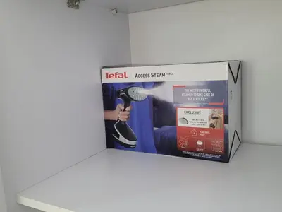 a box on a shelf with a hair dryer at Quiet, cozy resort apartment in Hurghada