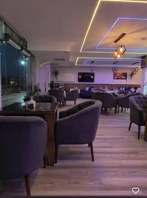 a restaurant with couches and tables in a room at Quiet, cozy resort apartment in Hurghada