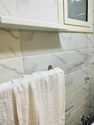a towel hanging on a towel rack in a bathroom at Quiet, cozy resort apartment in Hurghada