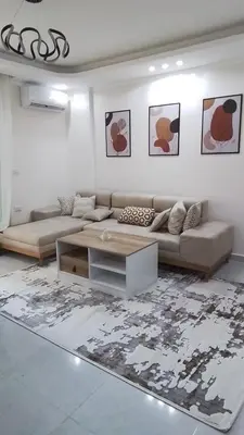 a living room with a couch and a coffee table at Quiet, cozy resort apartment in Hurghada