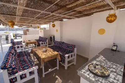 a room with several tables and chairs and a table at Home of ISIS in Luxor