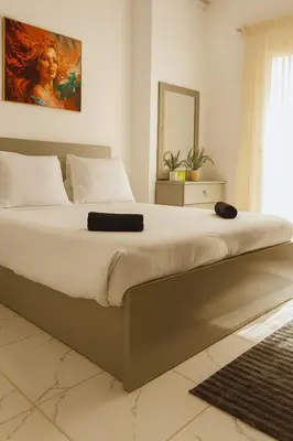 a large bed in a bedroom with a mirror at stylish cozy one bedroom apartment in Hurghada