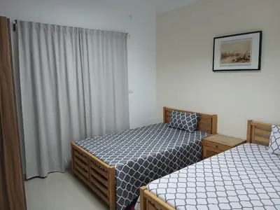 a bedroom with two beds and a window at Sea View 2 Bedroom Apartment in El-Hadaba in Hurghada