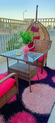 a glass table and two chairs on a rug at Hurghada neighborhoods in Hurghada