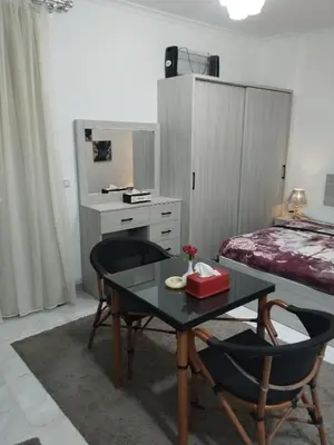 a room with a table and chairs and a bed at Hurghada neighborhoods in Hurghada