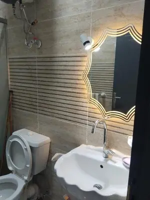 a bathroom with a sink and a toilet and a mirror at Hurghada neighborhoods in Hurghada