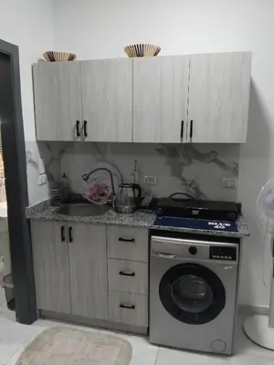 a kitchen with a sink and a washing machine at Hurghada neighborhoods in Hurghada