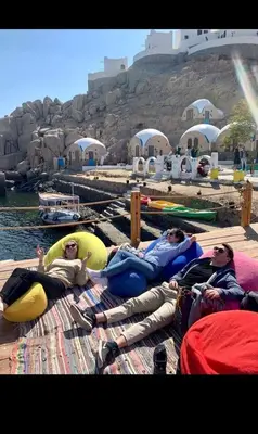 a group of people laying on rafts on the water at فندق اجيليكا in Aswân Reservoir Colony