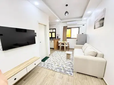 a living room with a couch and a tv at VERO Residence in Banī Ghālib