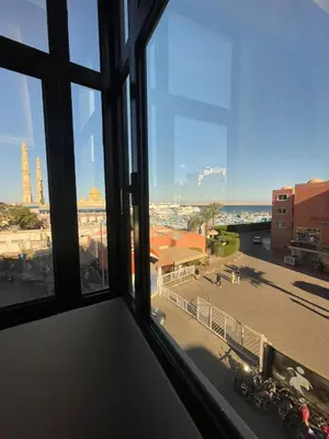 a view of a city from a window at VERO Residence in Banī Ghālib