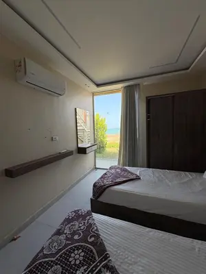 a bedroom with two beds and a large window at Casablanca Star Hotel, Hurghada in Hurghada
