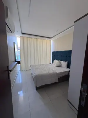 a bedroom with a bed with a blue headboard at Casablanca Star Hotel, Hurghada in Hurghada