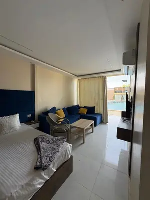 a bedroom with a bed and a blue couch at Casablanca Star Hotel, Hurghada in Hurghada