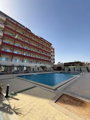 a swimming pool in front of a large building at Casablanca Star Hotel, Hurghada in Hurghada