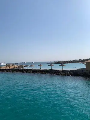 a group of umbrellas on a pier in the water at Sea Light Arabia on the beach in Hurghada
