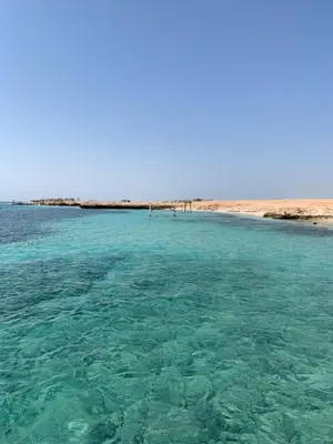 a body of water with a beach in the background at Sea Light Arabia on the beach in Hurghada