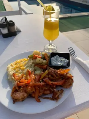 a plate of food on a table with a drink at Sea Light Arabia on the beach in Hurghada