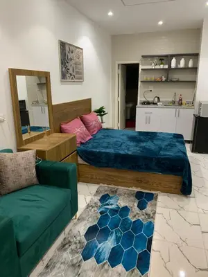 a bedroom with a bed and a green couch at Sea Light Arabia on the beach in Hurghada