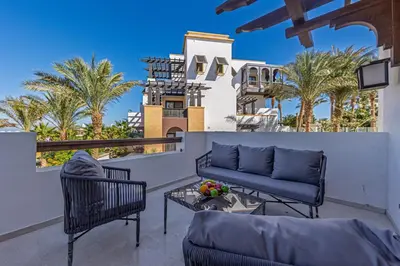 a patio with a couch and chairs and a table at Dreamy gateway in Ancient Sands in Hurghada