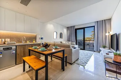 a kitchen and living room with a couch and a table at Dreamy gateway in Ancient Sands in Hurghada