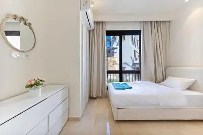 a white bedroom with a bed and a window at Dreamy gateway in Ancient Sands in Hurghada