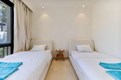 two twin beds in a room with a window at Dreamy gateway in Ancient Sands in Hurghada
