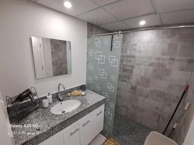 a bathroom with a sink and a shower at Scandic Resort holiday apartment in Hurghada
