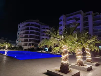a palm tree with lights in front of a building at Scandic Resort holiday apartment in Hurghada