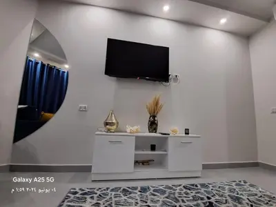 a living room with a flat screen tv on a wall at Scandic Resort holiday apartment in Hurghada