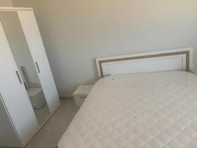 a bedroom with a bed and a mirror at Apt at Panorama view in Hurghada