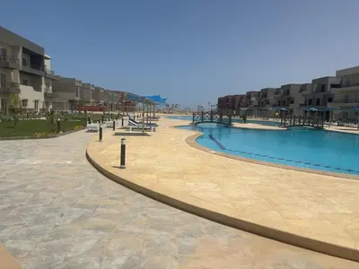 an empty swimming pool in a resort with buildings at Apt at Panorama view in Hurghada